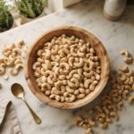 Anacardi: Valori Nutrizionali a Confronto con il Resto della Frutta Secca Anacardi valori nutrizionali: ciotola di anacardi crudi su piano da cucina